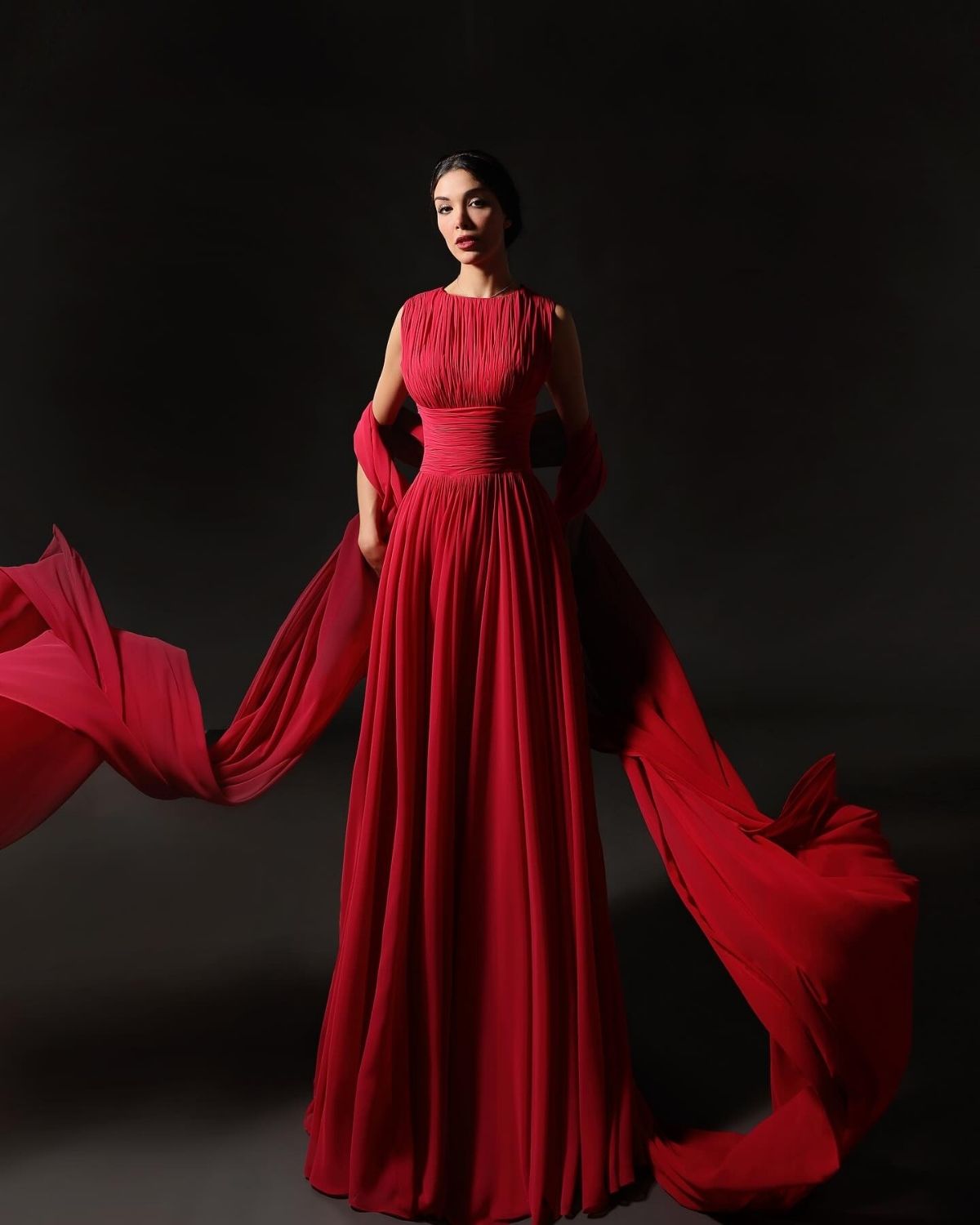 Red pleated sleeveless gathered gown