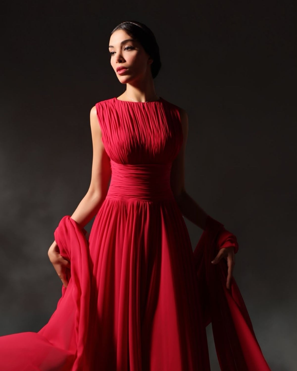Red pleated sleeveless gathered gown