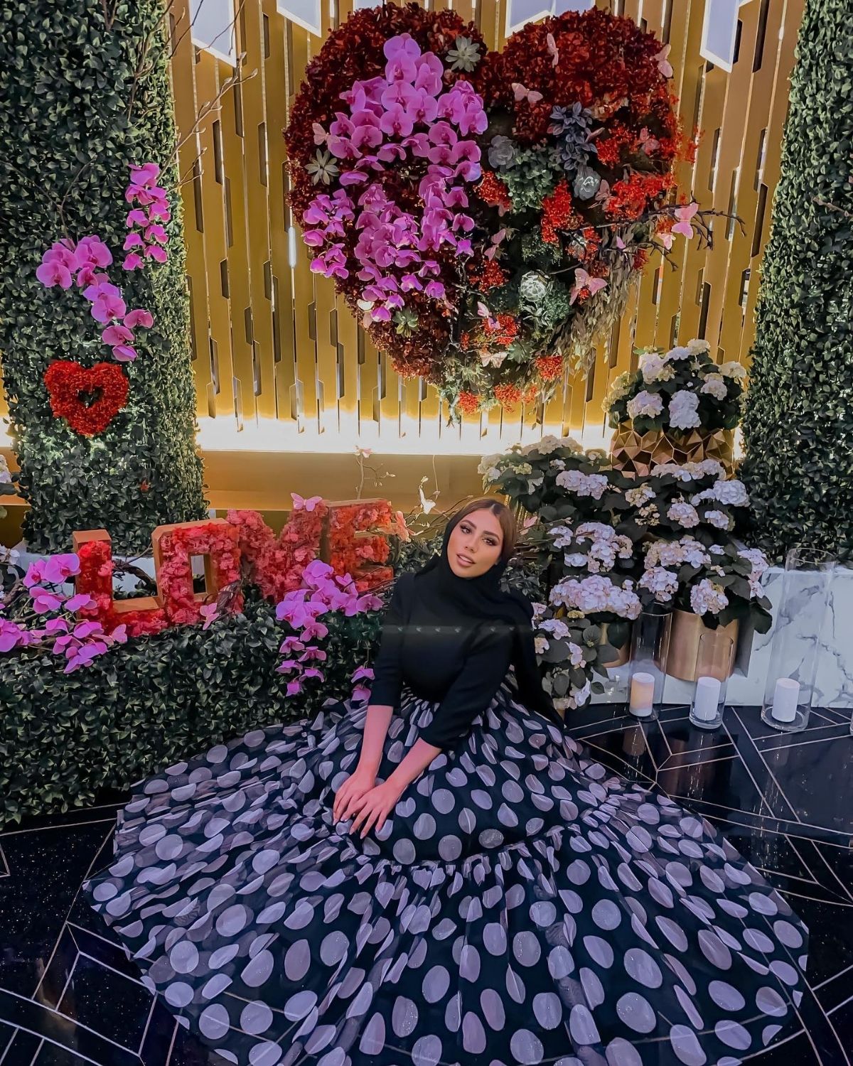 Rahaf Elshami in white and light purple polka dot gathered dress